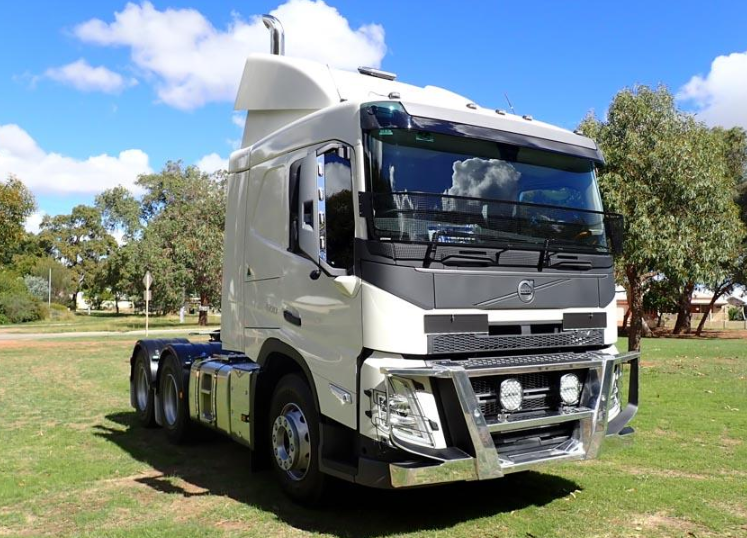 White Volvo prime mover and chassis parked on grass